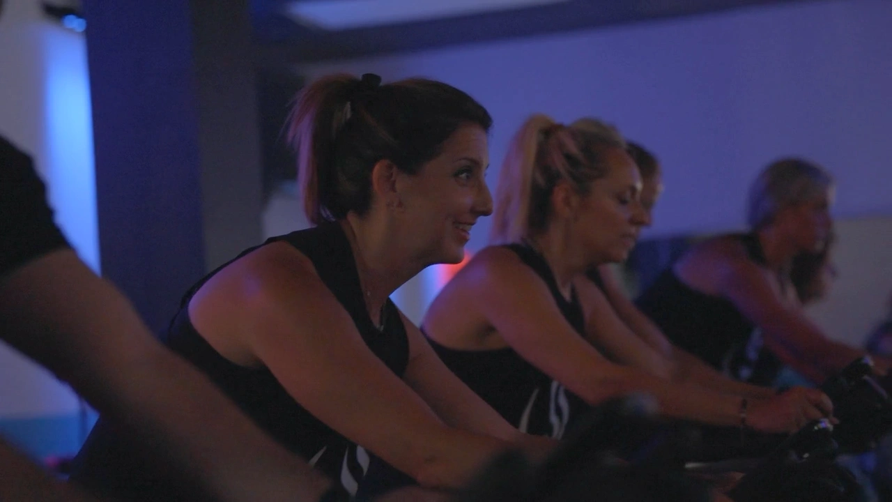 Studio Spin members riding together in the indoor cycling room.