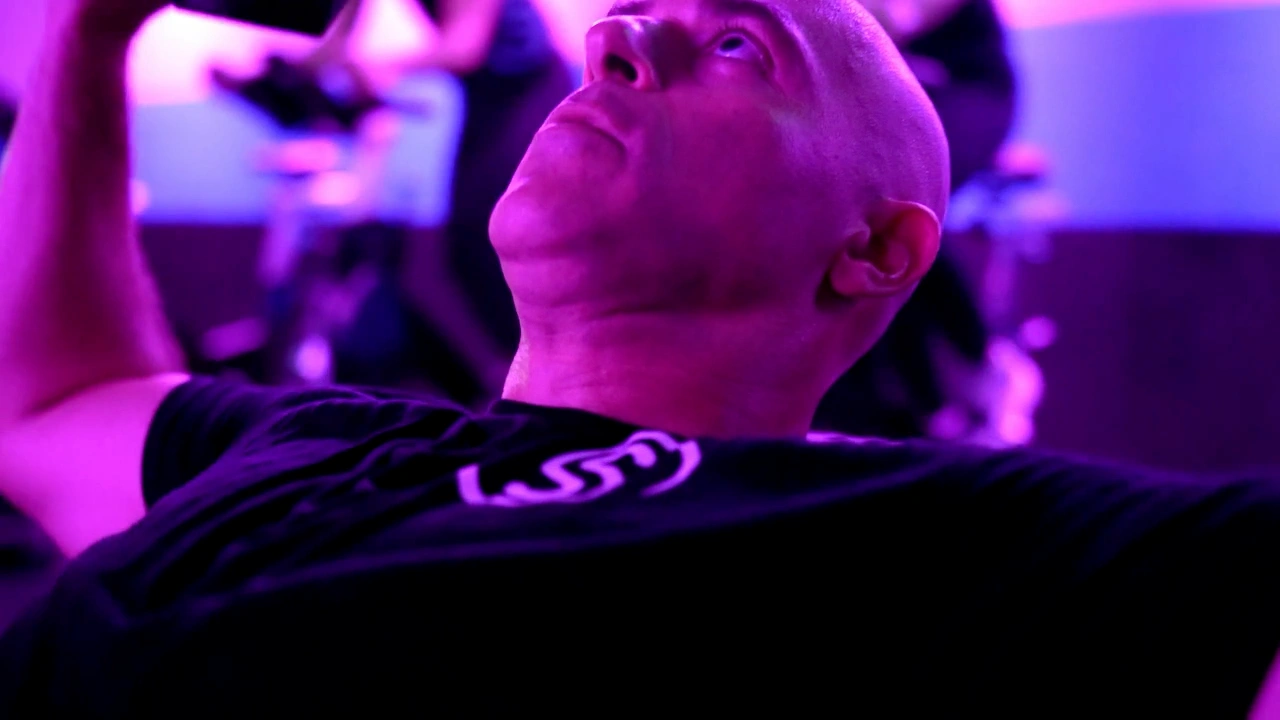 A Studio Spin member lifting a dumbbell.