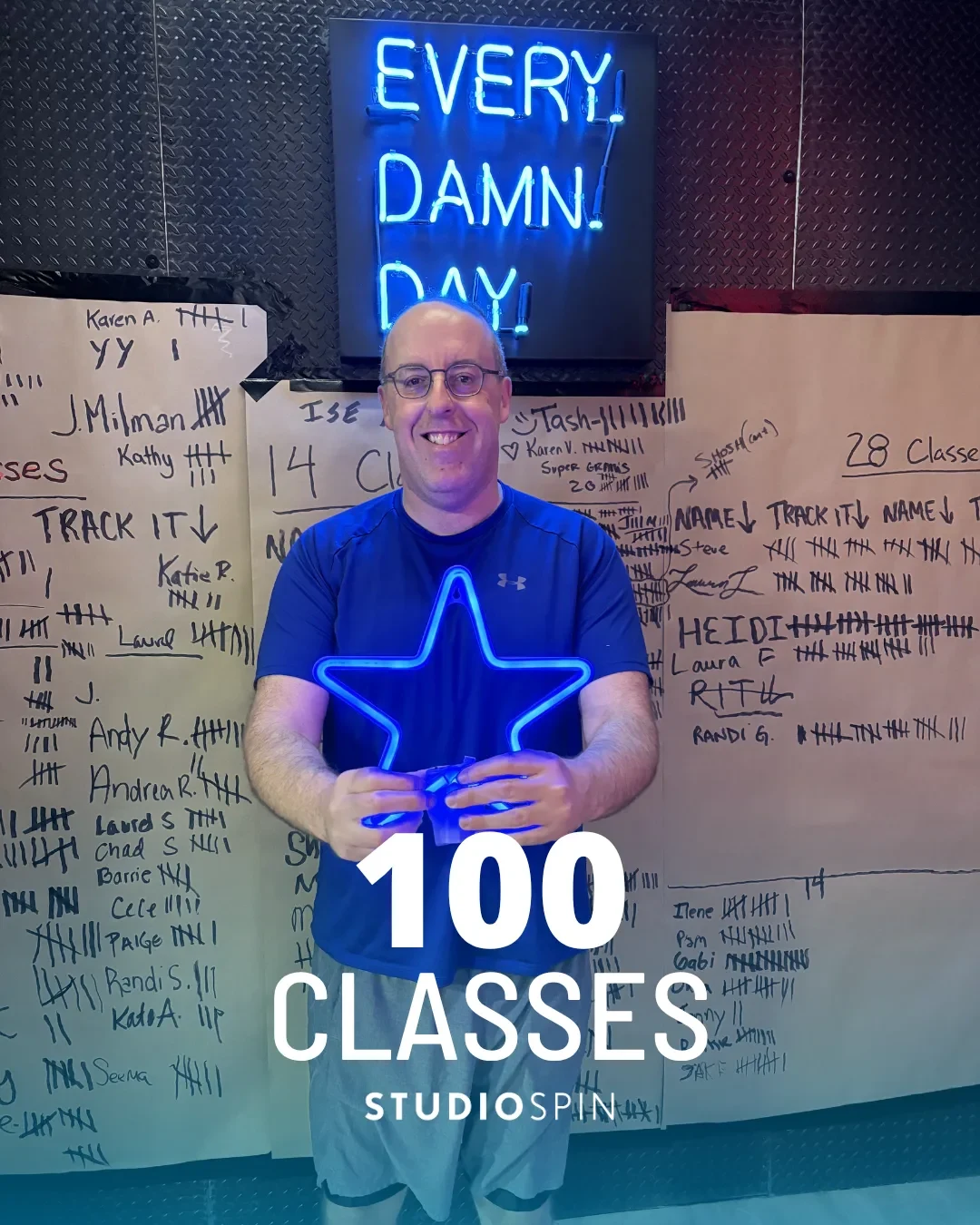 A Studio Spin member celebrating 100 classes under the Every Damn Day neon sign.