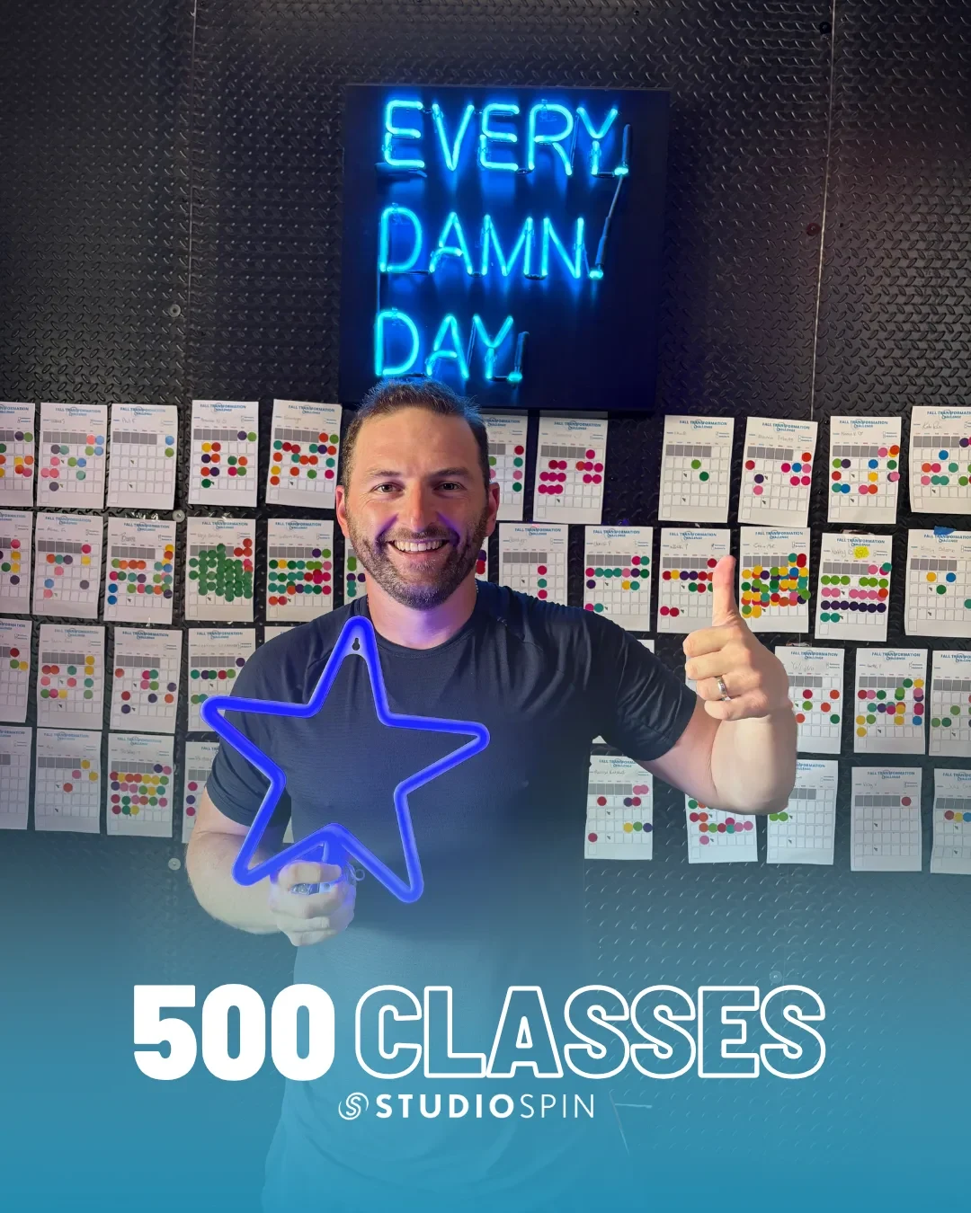 A Studio Spin member celebrating 500 classes under the Every Damn Day neon sign.