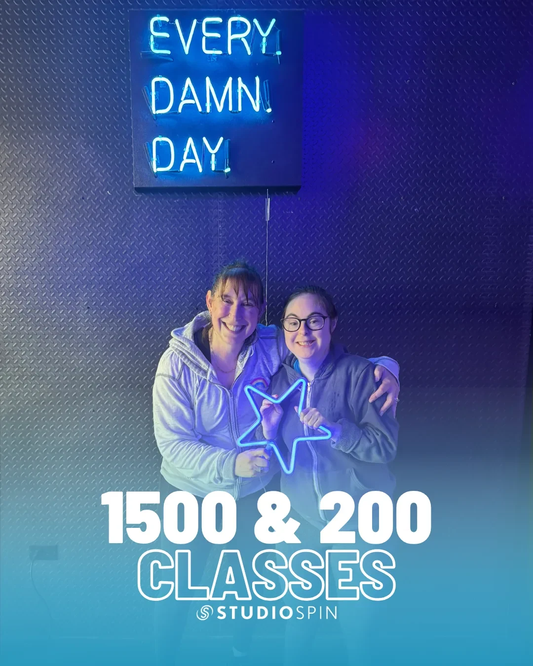 A Studio Spin member celebrating 1,500 classes under the Every Damn Day neon sign.