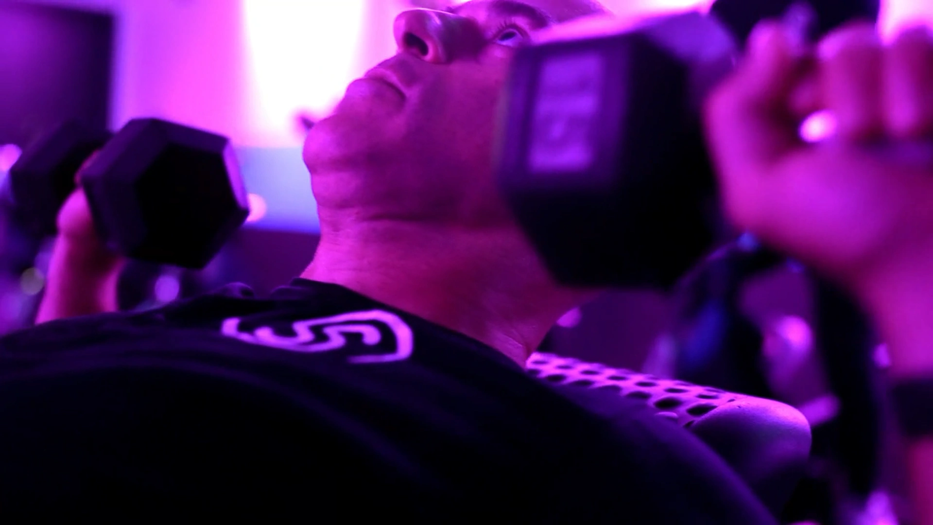 A Studio Spin member training with dumbbells during LIFT.