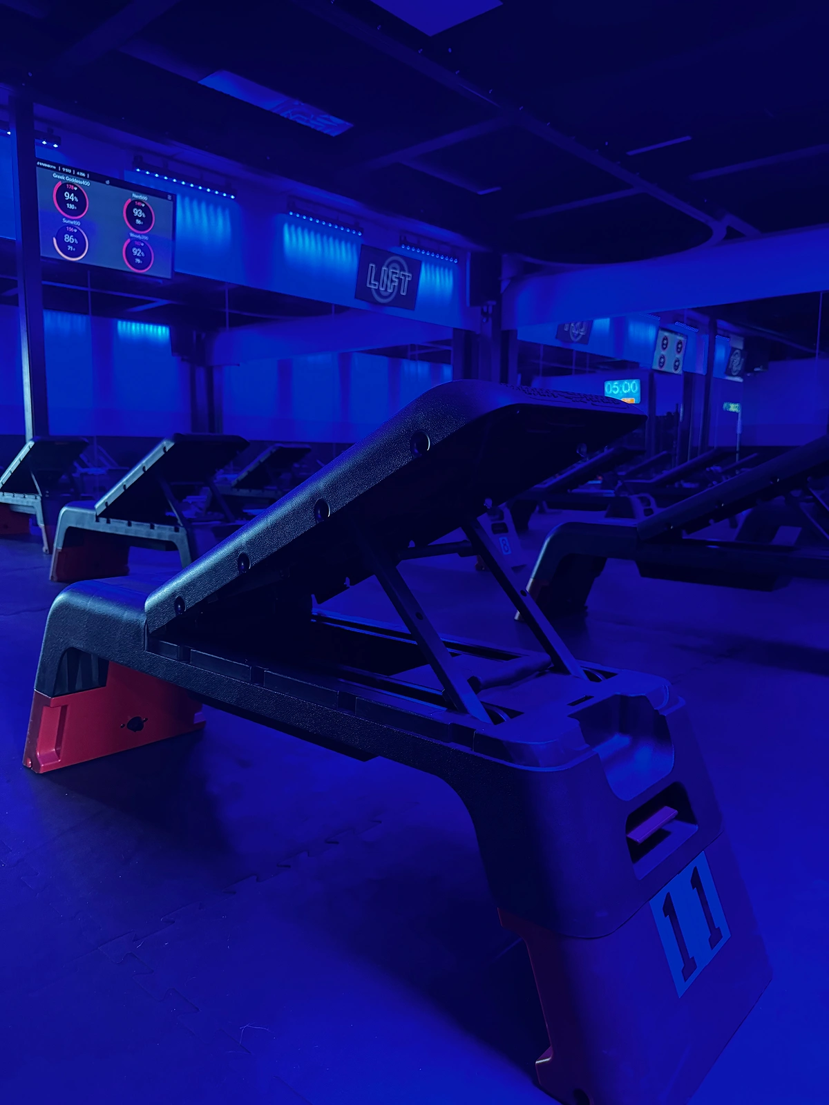 A Studio Spin member lifting a dumbbell during a strength workout.