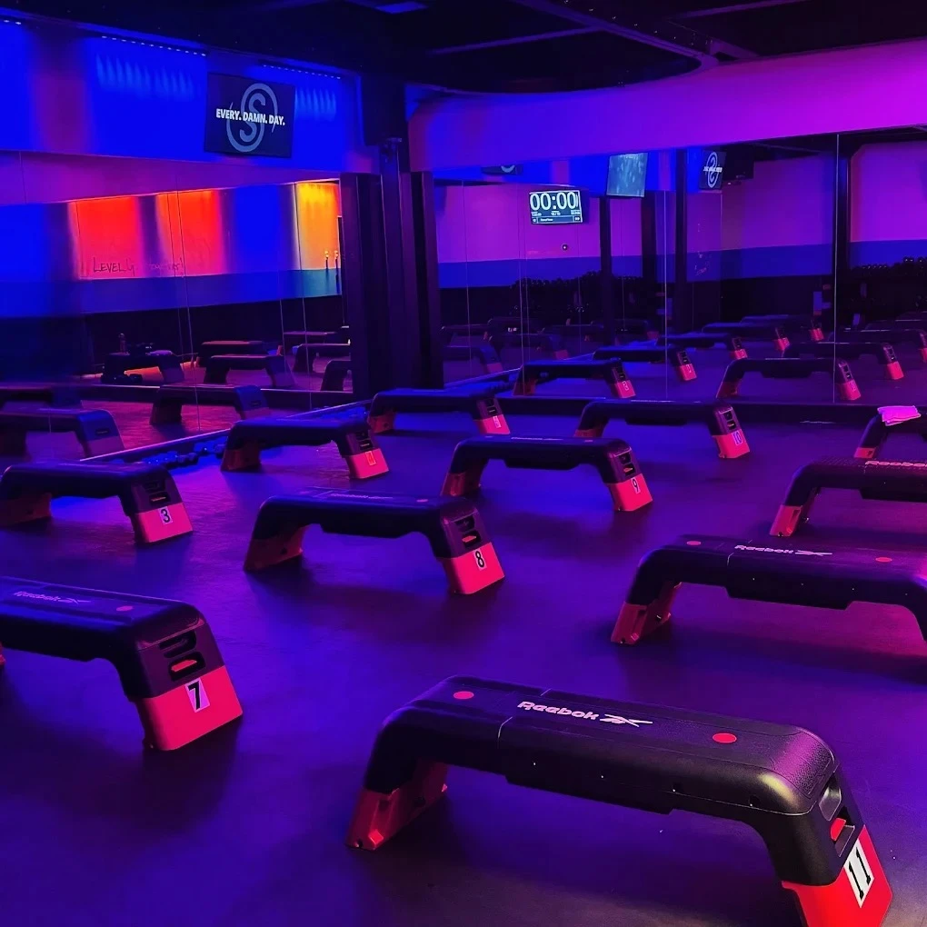 The Studio Spin Glenview-Northbrook training room lit in blue and purple.