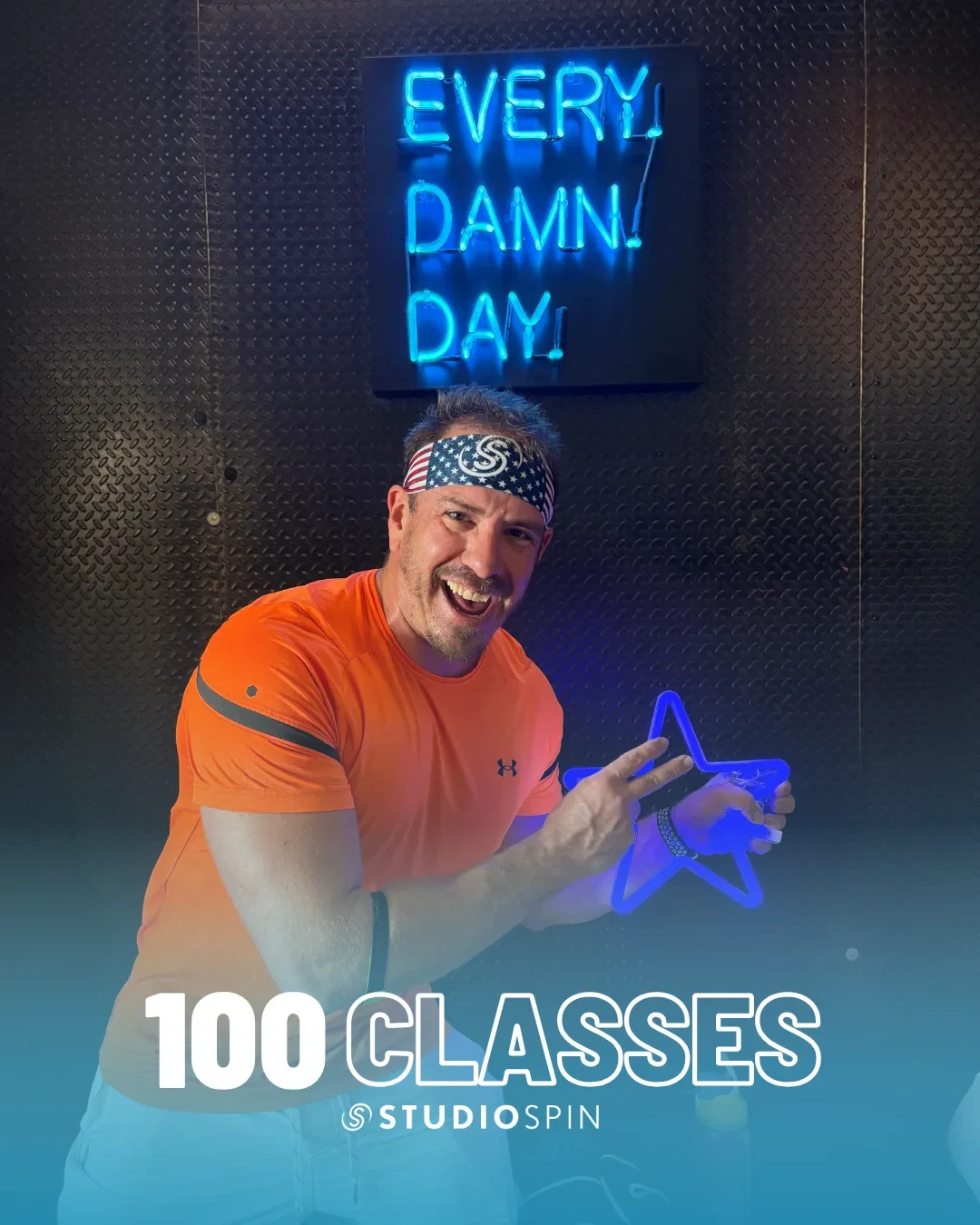 A Studio Spin member celebrating 100 classes under the Every Damn Day neon sign.