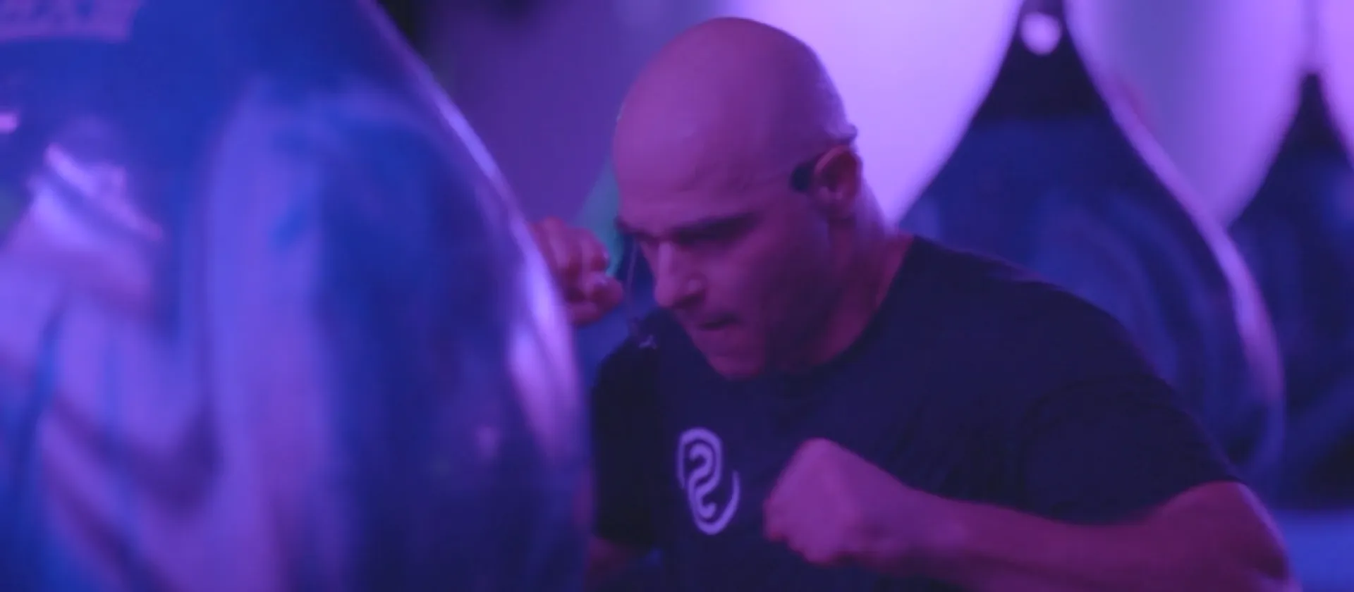 A Studio Spin member boxing at an individual AquaBag during RUMBLE.