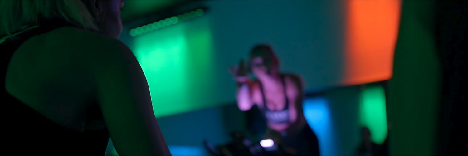 Studio Spin members training under vibrant studio lighting