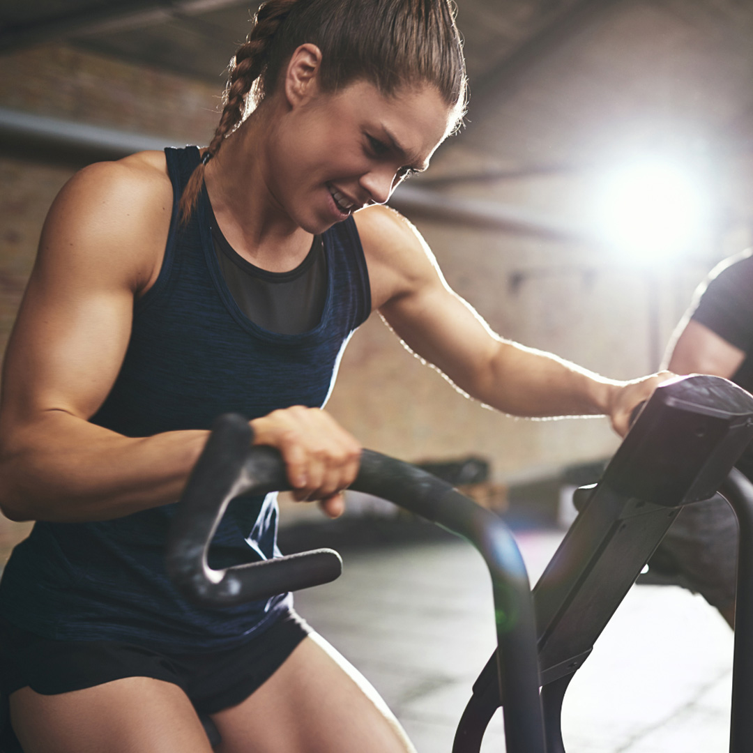 A woman using an exercise bike